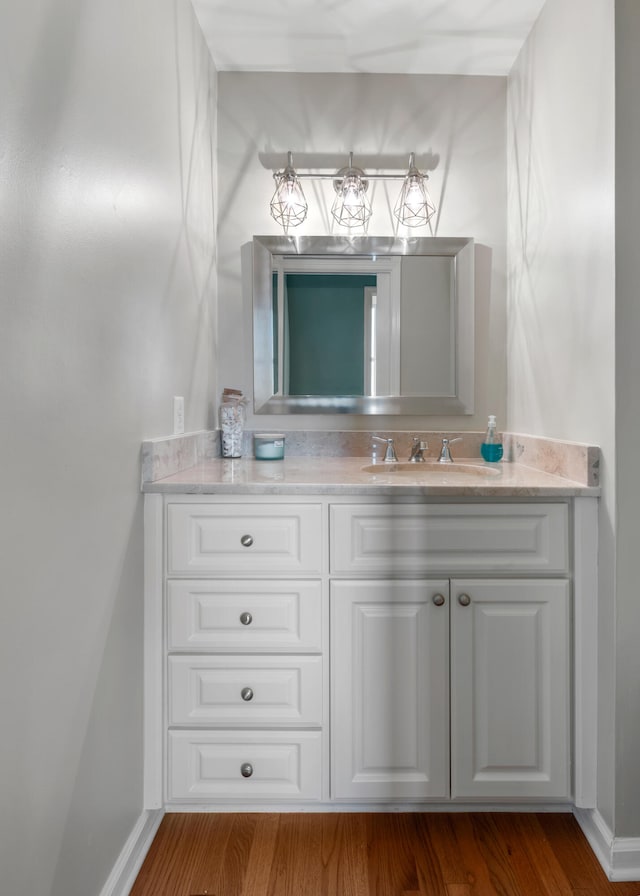 bathroom featuring vanity and hardwood / wood-style flooring