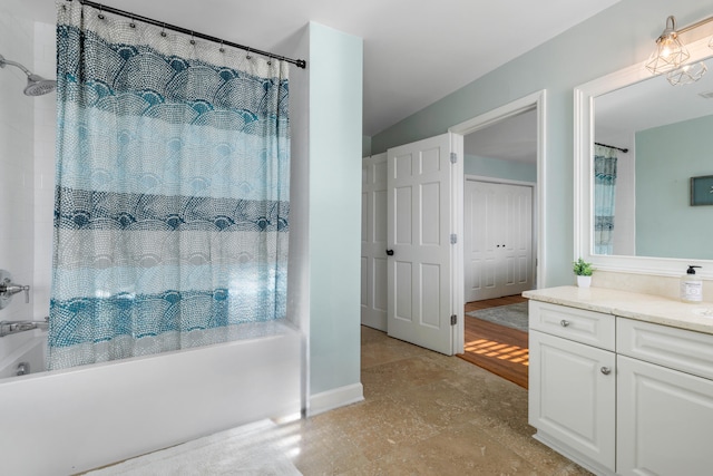 bathroom featuring shower / bath combo with shower curtain and vanity