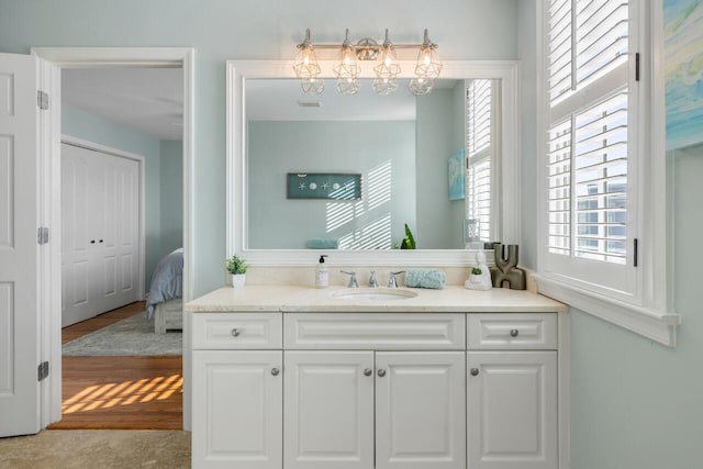 bathroom with hardwood / wood-style floors and vanity