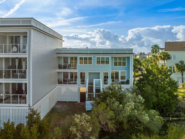 back of house featuring a balcony