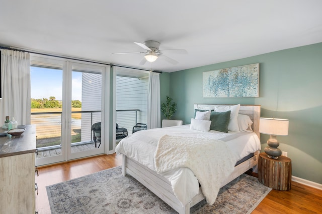 bedroom with hardwood / wood-style flooring, ceiling fan, and access to exterior