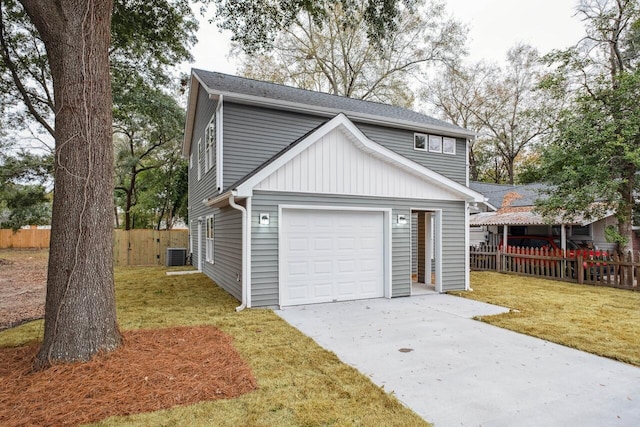 garage with cooling unit and a lawn