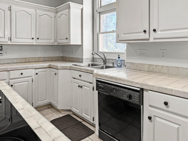 kitchen with dishwasher, light countertops, light tile patterned flooring, white cabinets, and a sink