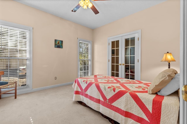 carpeted bedroom featuring french doors, a ceiling fan, and baseboards