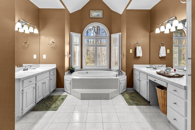 bathroom with lofted ceiling, two vanities, tile patterned floors, and a sink