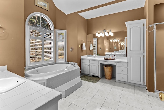 full bath with a sink, two vanities, a bath, and tile patterned flooring