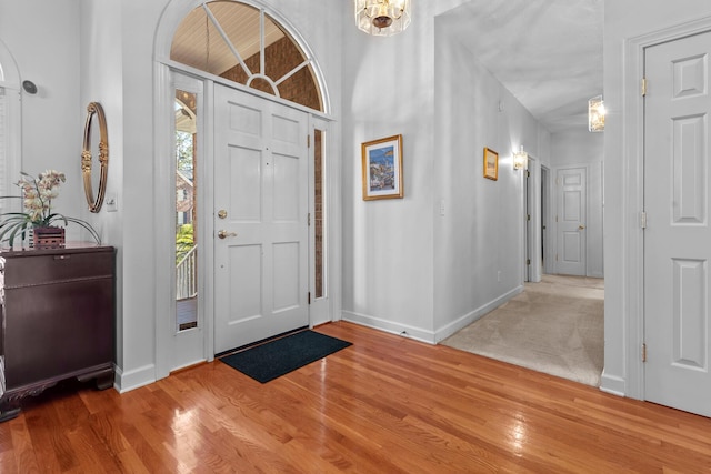 foyer featuring baseboards and wood finished floors