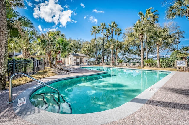 community pool featuring a patio area and fence