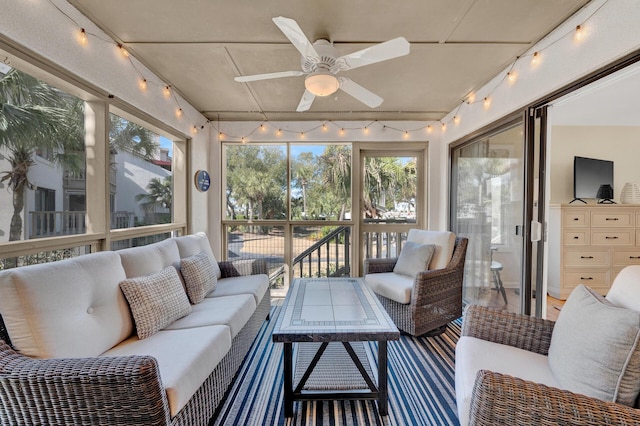 sunroom featuring a ceiling fan and rail lighting