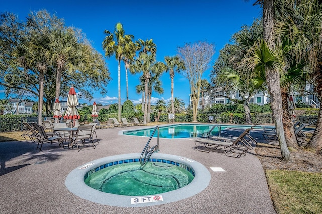 pool featuring a patio area and a community hot tub