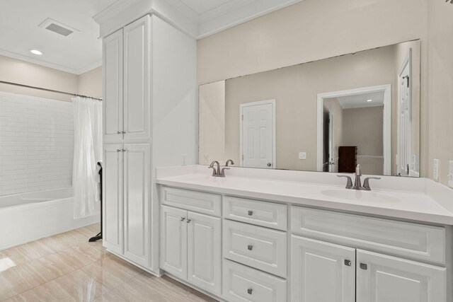 bathroom with tile patterned floors, ornamental molding, shower / tub combo with curtain, and vanity