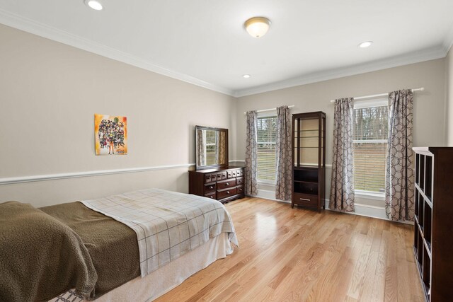 bedroom featuring light hardwood / wood-style flooring and ornamental molding