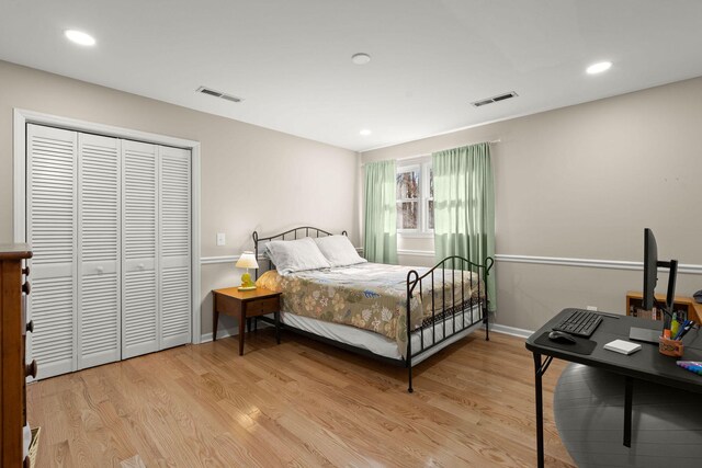 bedroom with a closet and light hardwood / wood-style floors