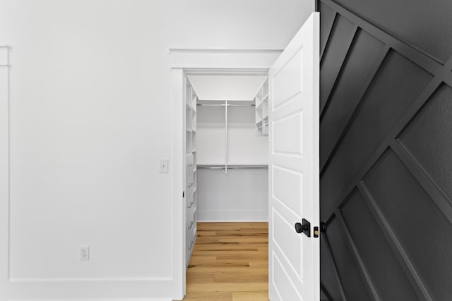 spacious closet featuring hardwood / wood-style floors