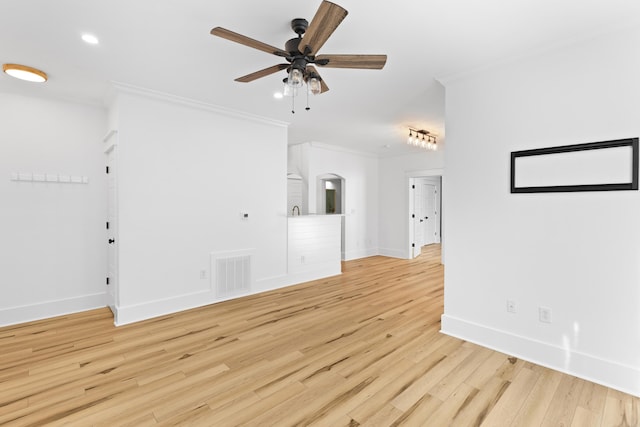 interior space featuring ceiling fan, light hardwood / wood-style floors, and ornamental molding