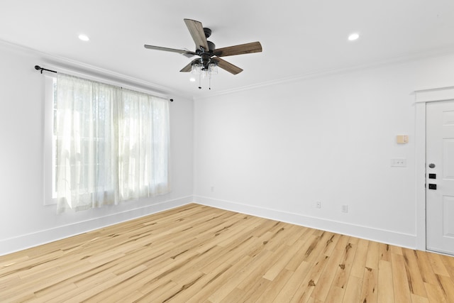 spare room featuring crown molding, ceiling fan, and light hardwood / wood-style floors