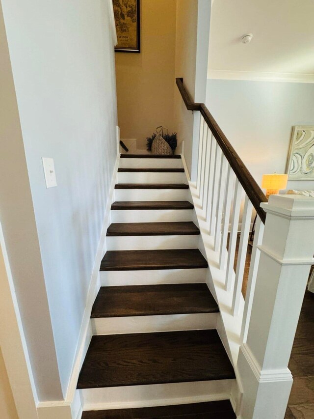 stairs with baseboards and ornamental molding