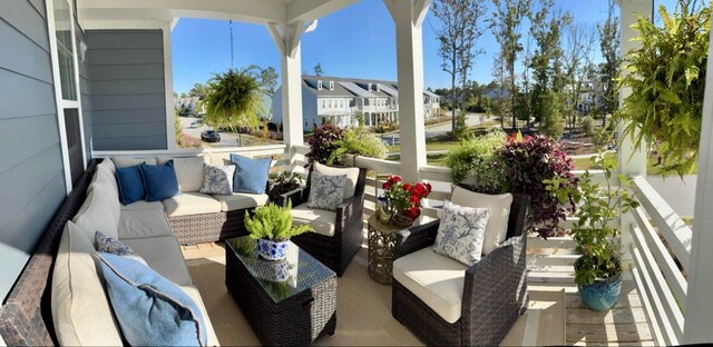 view of patio / terrace featuring a residential view, an outdoor living space, and a balcony