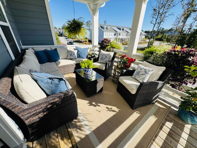 wooden deck with a residential view and an outdoor hangout area