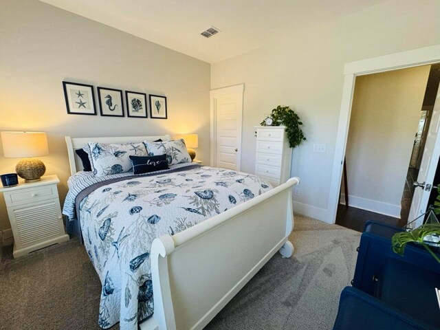 bedroom featuring visible vents, carpet flooring, and baseboards