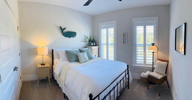 carpeted bedroom with baseboards and ceiling fan