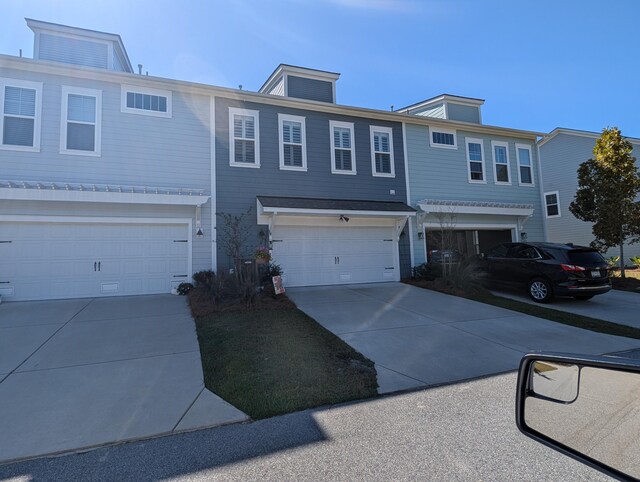 townhome / multi-family property with concrete driveway and an attached garage