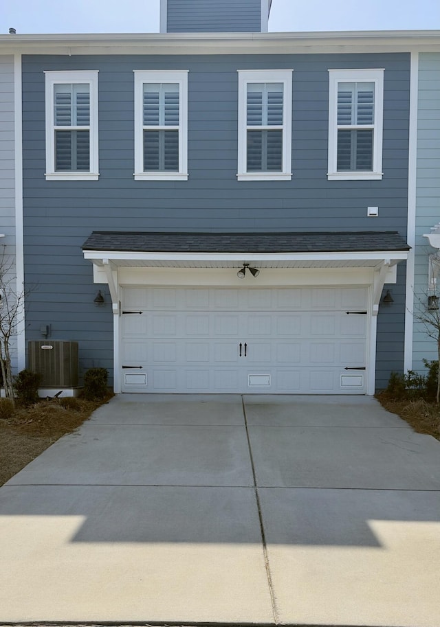 exterior space featuring central air condition unit and concrete driveway