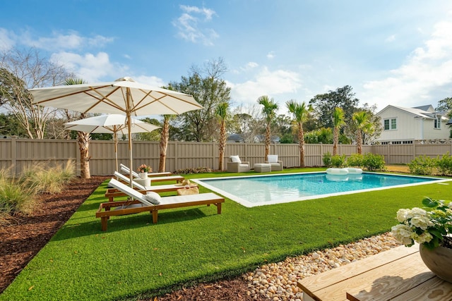 view of pool featuring a lawn