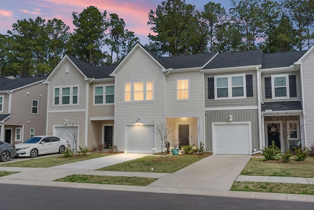 view of property featuring a garage and driveway