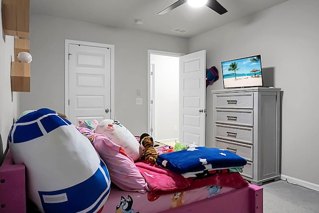 bedroom featuring light colored carpet, ceiling fan, visible vents, and baseboards