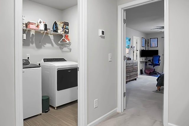 laundry room with laundry area, independent washer and dryer, and baseboards