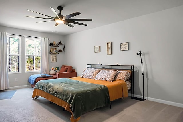 bedroom featuring carpet floors, a ceiling fan, and baseboards