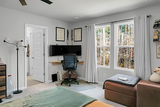 office area featuring carpet flooring, ceiling fan, and baseboards