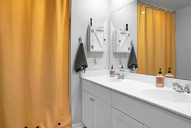 bathroom featuring double vanity, a shower with curtain, and a sink