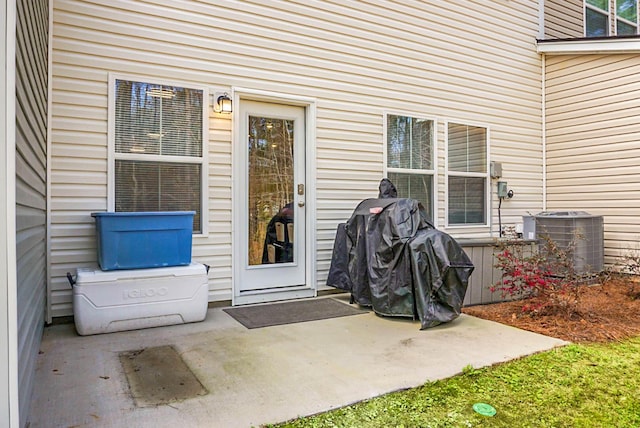 doorway to property with central AC unit and a patio area