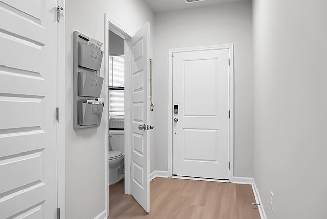 interior space featuring light wood finished floors and baseboards