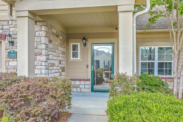 271 Village Stone Cir, Summerville, SC 29486 - view of exterior entry featuring stone siding, roof with shingles, and a porch
