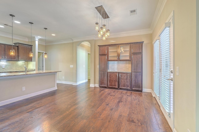 271 Village Stone Cir, Summerville, SC 29486 - unfurnished living room with arched walkways, dark wood-style floors, recessed lighting, and ornamental molding