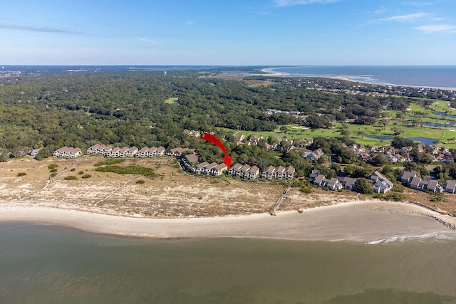 birds eye view of property featuring a water view and a beach view