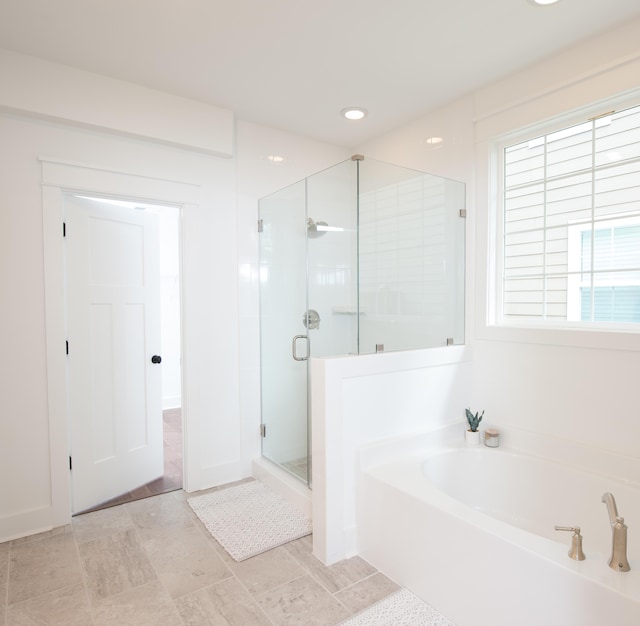 full bath featuring a stall shower, a bath, and recessed lighting