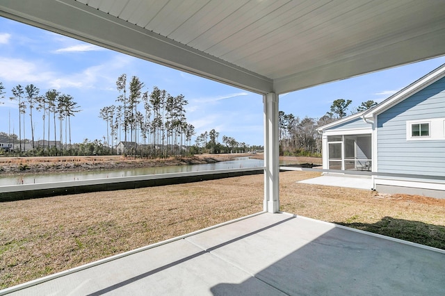 view of patio / terrace featuring a water view and a sunroom