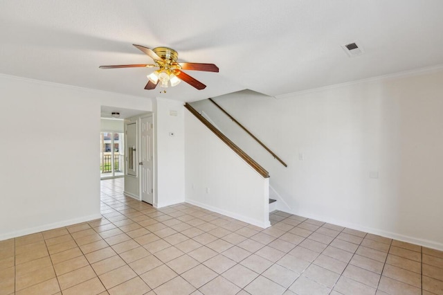 empty room with visible vents, crown molding, stairs, and a ceiling fan