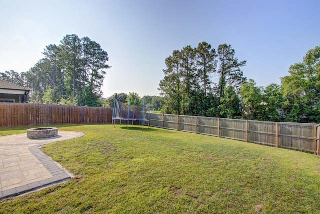 596 Wayton Cir, Moncks Corner, SC 29461 - view of yard with an outdoor fire pit, a trampoline, and a patio