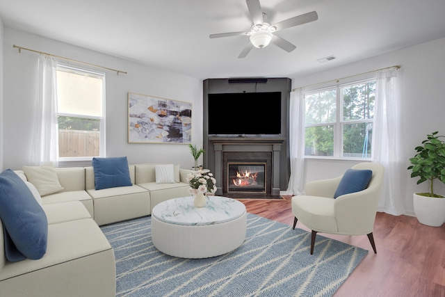 596 Wayton Cir, Moncks Corner, SC 29461 - living room featuring plenty of natural light, wood finished floors, a fireplace with flush hearth, and ceiling fan