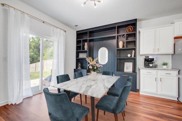 596 Wayton Cir, Moncks Corner, SC 29461 - dining area featuring light wood-style flooring and built in shelves
