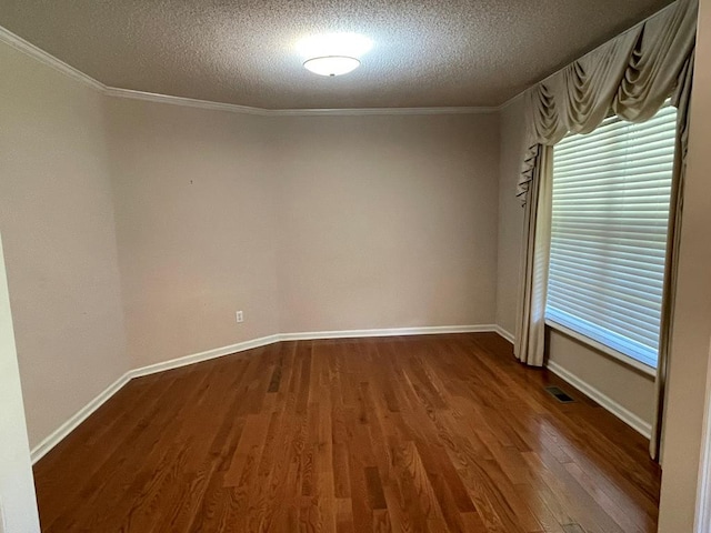 unfurnished room with a textured ceiling, crown molding, and dark hardwood / wood-style flooring