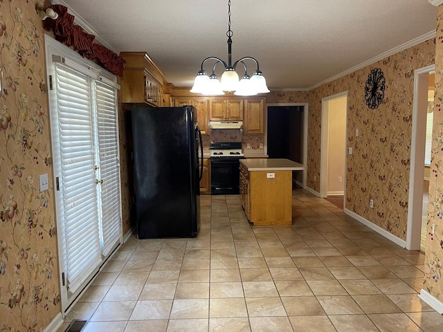 kitchen featuring a chandelier, pendant lighting, a kitchen island, white range with gas stovetop, and black fridge