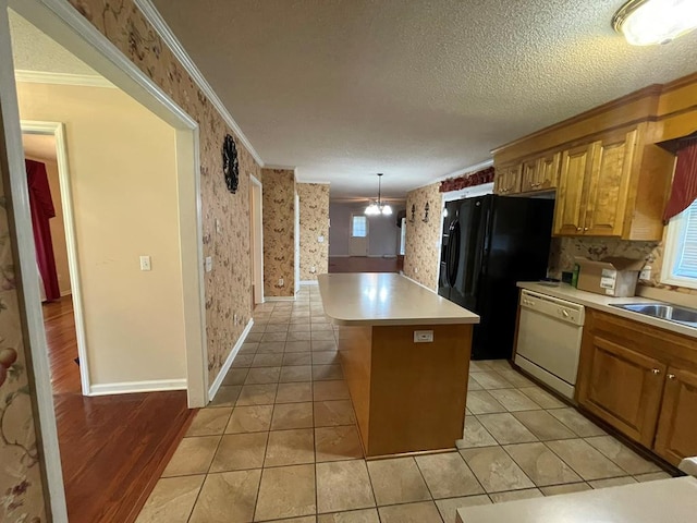 kitchen featuring ceiling fan, a center island, crown molding, hanging light fixtures, and dishwasher