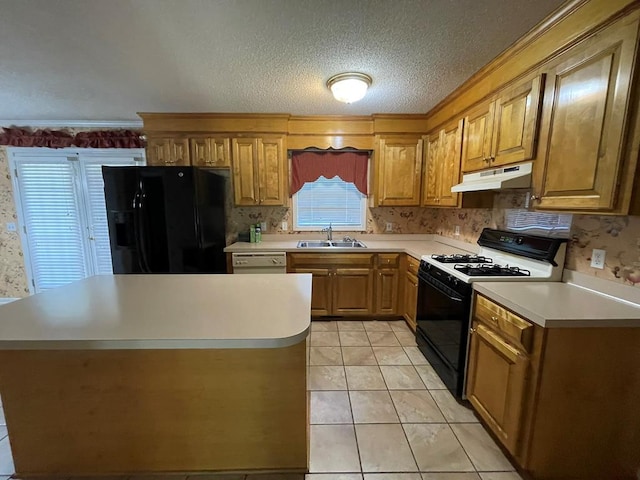 kitchen featuring light tile patterned flooring, sink, a textured ceiling, and black appliances