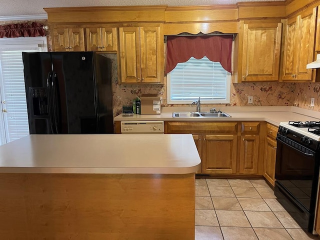 kitchen featuring premium range hood, light tile patterned floors, sink, a textured ceiling, and black appliances